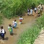 Kids crossing the river on their way to the school.